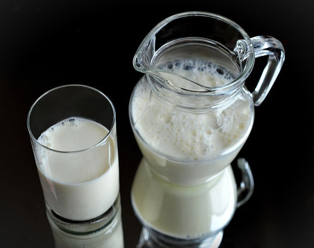 Is Milk Causing Your Acne? The Truth About Dairy and Breakouts | A glass pitcher of milk and a glass of milk side by side