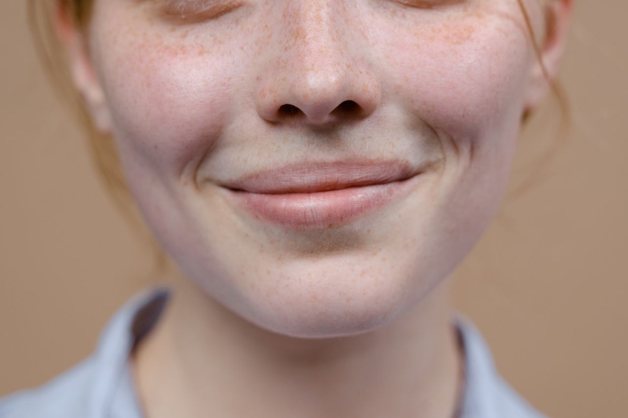 smiling woman showing skin pore