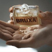 A close-up view of hands pouring out BRUXA Body Oil of Winter 100ml