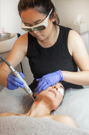 Caucasian woman receiving laser skin treatment at a spa