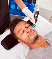 a man of color receiving a facial treatment